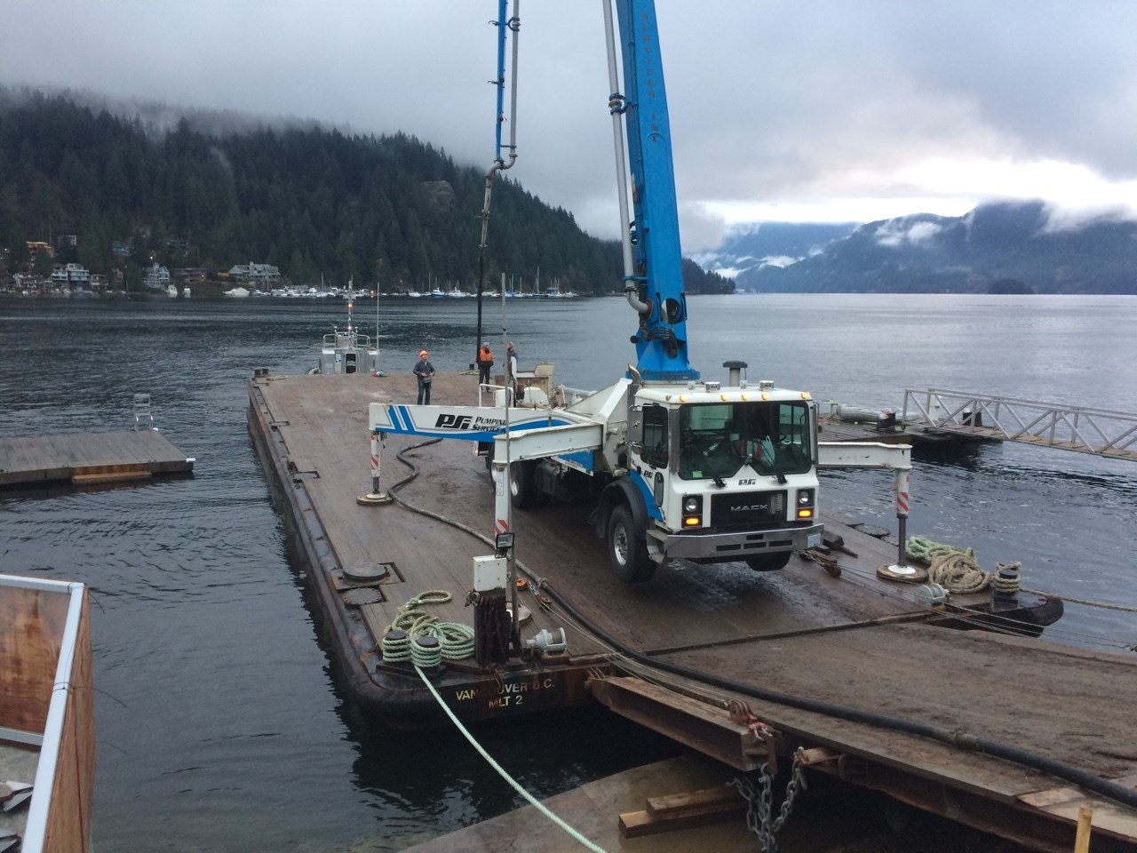 Large concrete machinery sits on a barge