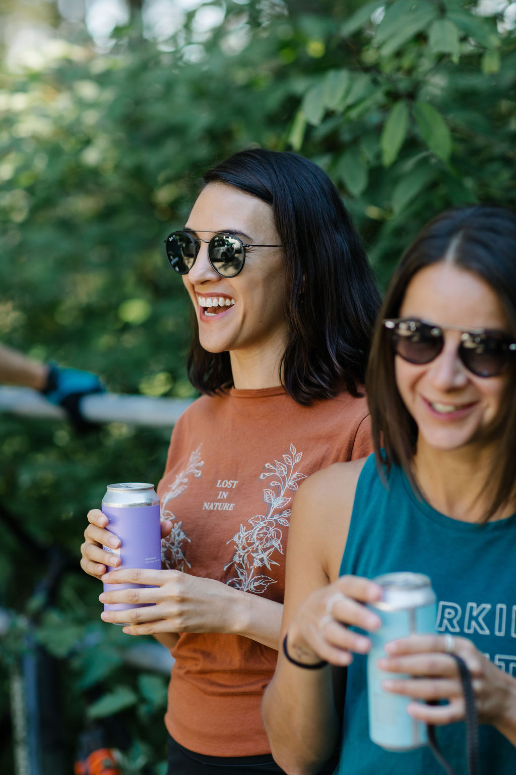 Two teammates outside holding beverages
