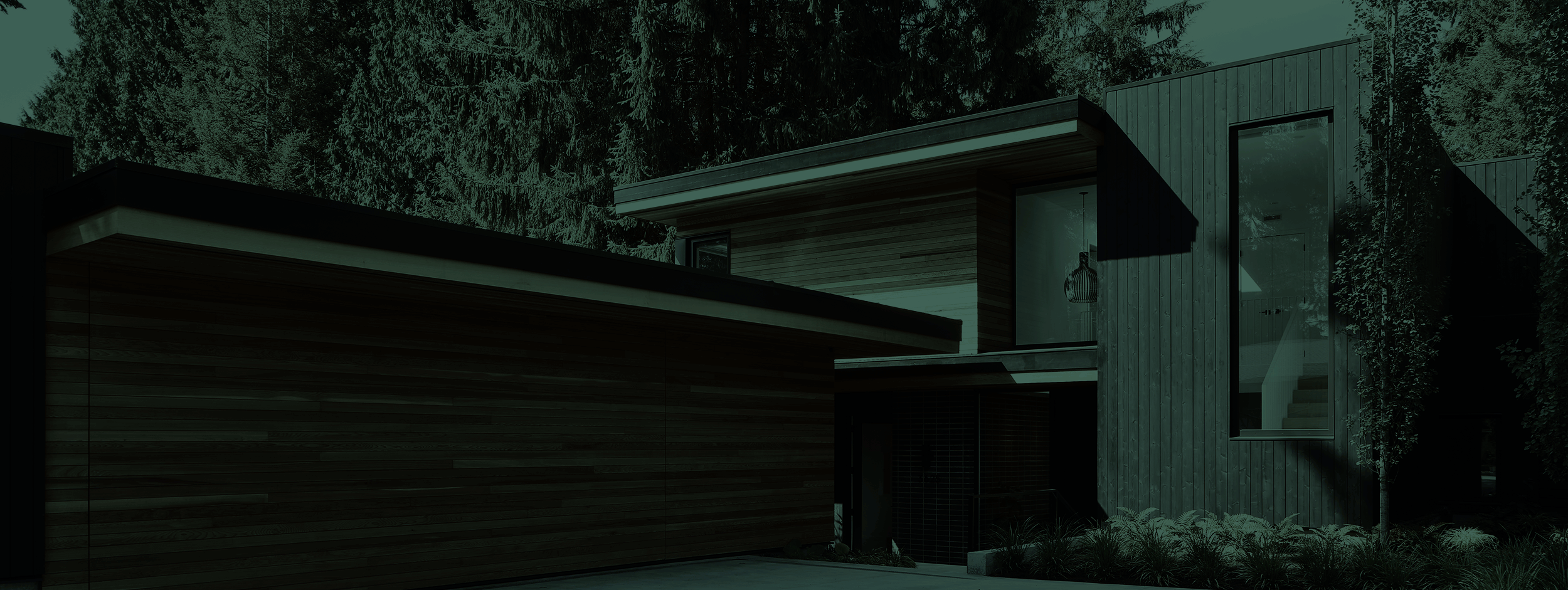 The exterior of a custom home behind a dark green overlay.