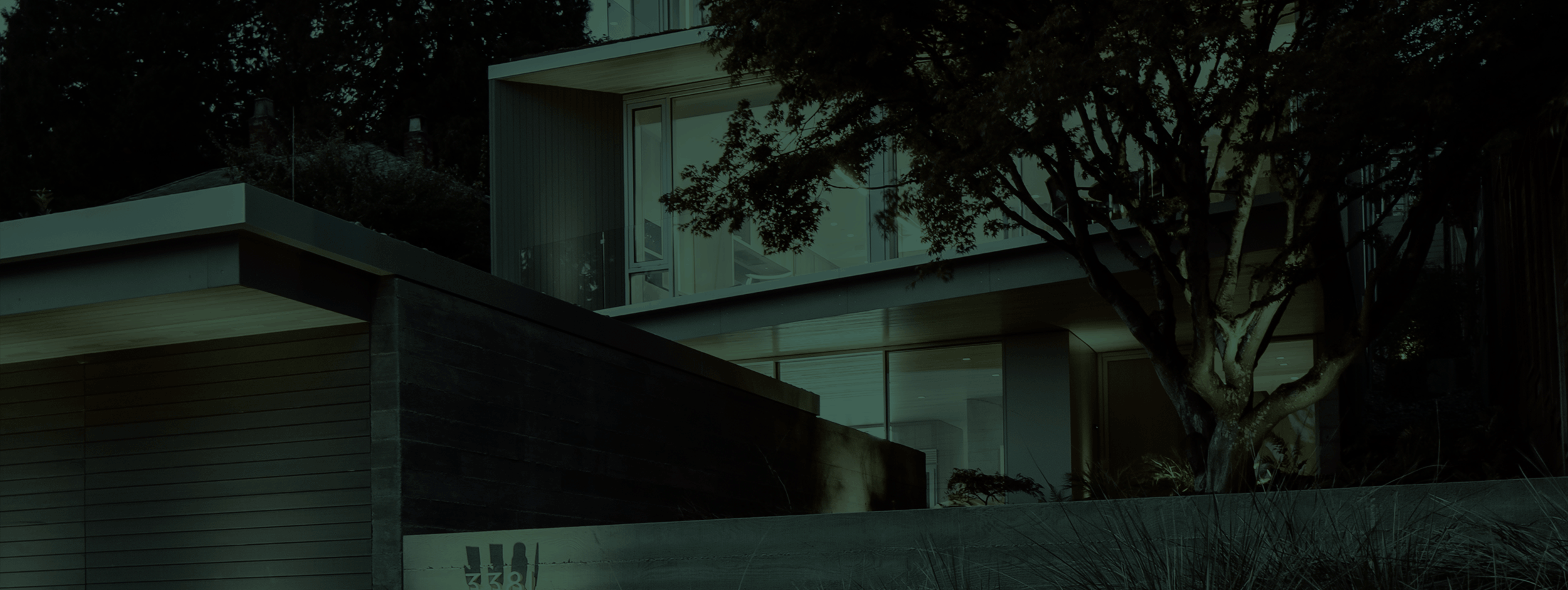 The front of a home behind a dark green overlay.